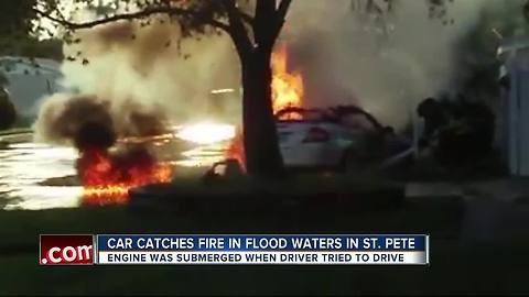 Car catches fire in flood waters in St. Pete