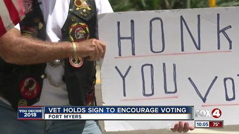 Vet Holds Sign to Encourage Voting