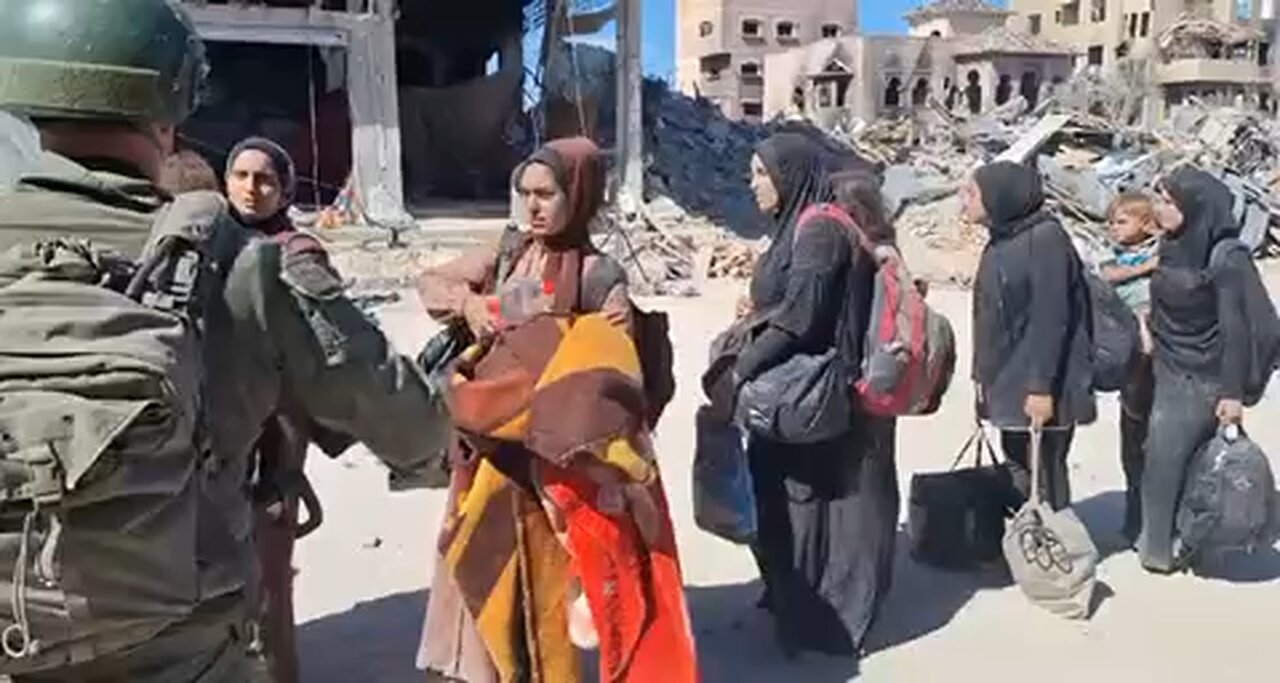 IDF soldier treats well Gazans who are fleeing Jabalia North Gaza.