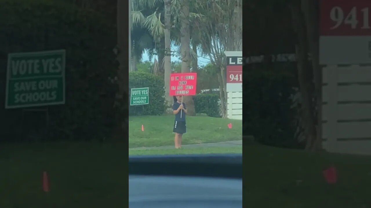 Parents force kid to hold a sign reading “I am a bully”