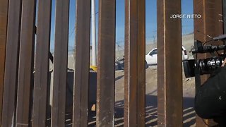 Migrants break through border fence