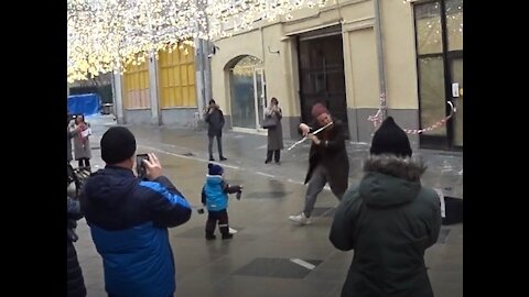 Little kid decided to help a street musician