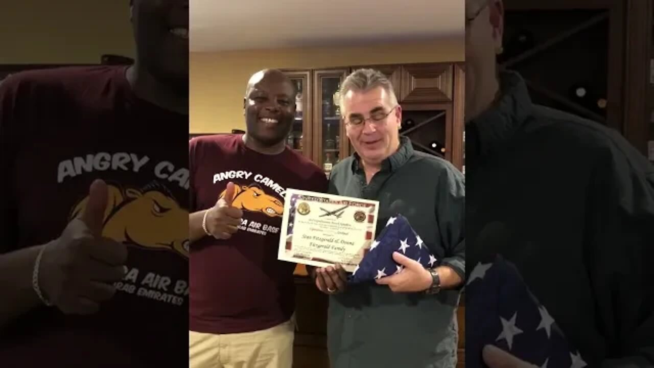 Air Force sergeant Frederick Mulika presents combat flown flag to Stan & Donna Fitzgerald VFAF