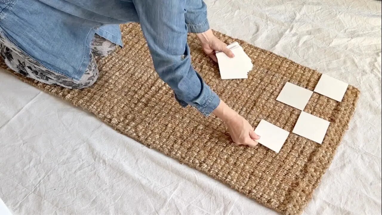 Lay squares of paper on a rug for this brilliant decor hack!