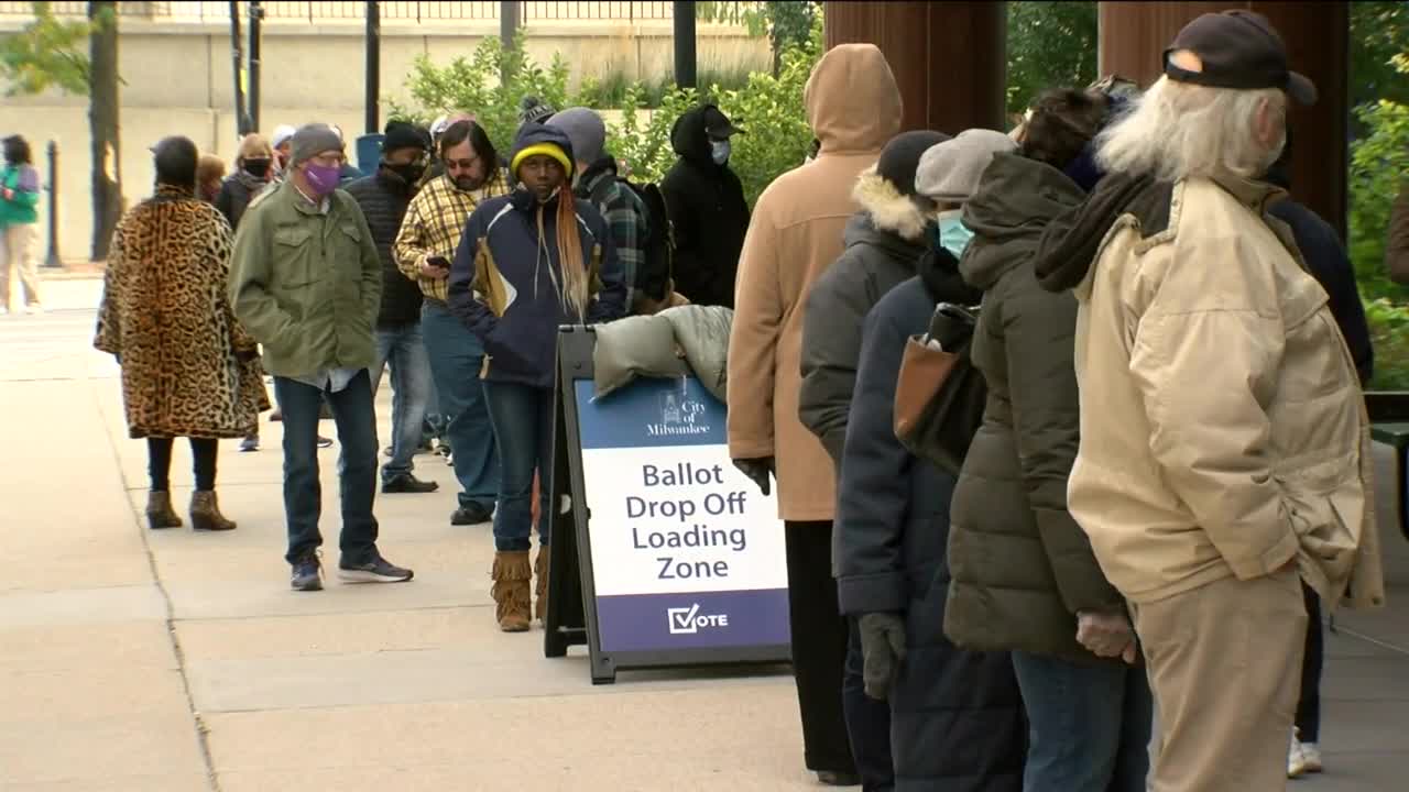 Voters wait in long lines as early in-person voting begins in the battleground state of Wisconsin