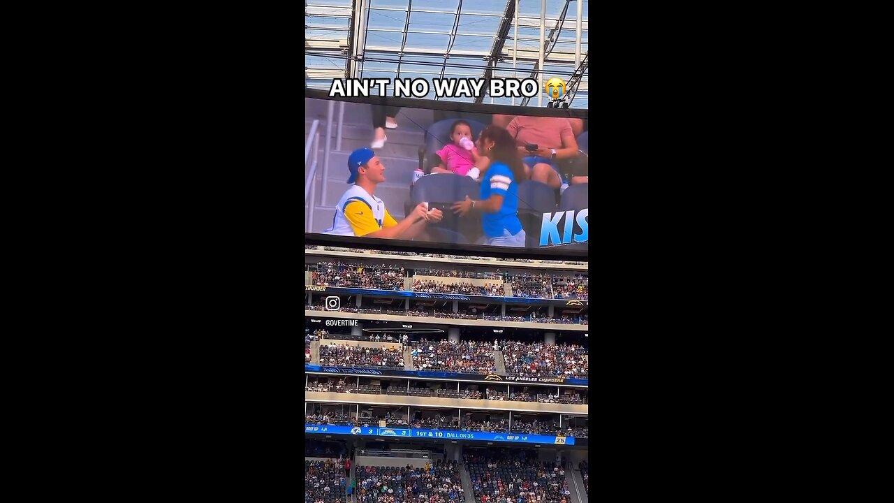 Man proposing to his girlfriend at an NFL game, only to be rejected and have food spilled on him