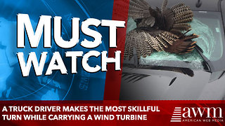 A truck driver makes the most skillful turn while carrying a wind turbine