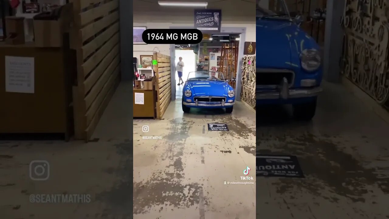 1964 MG MGB driving into Miles Through Time Automotive Museum
