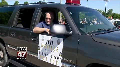 Flint airport officer stabbed in attack joins July 4 parade