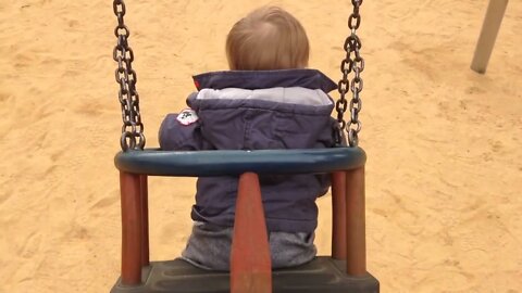 The child seems to be enjoying the swing on the swing