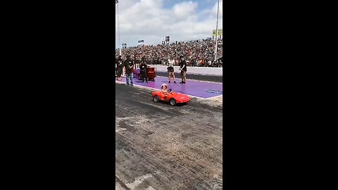 Cute little girl making drift donut with toy car