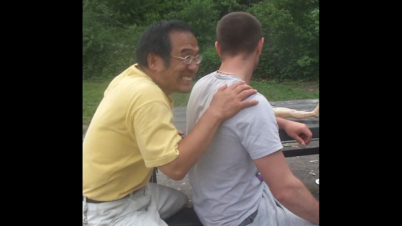 Luodong Massages Man In Grey Shirt On Picnic Bench