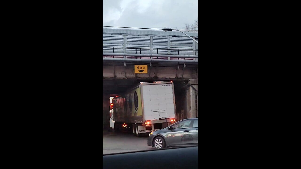 Trucker Hits Low Bridge