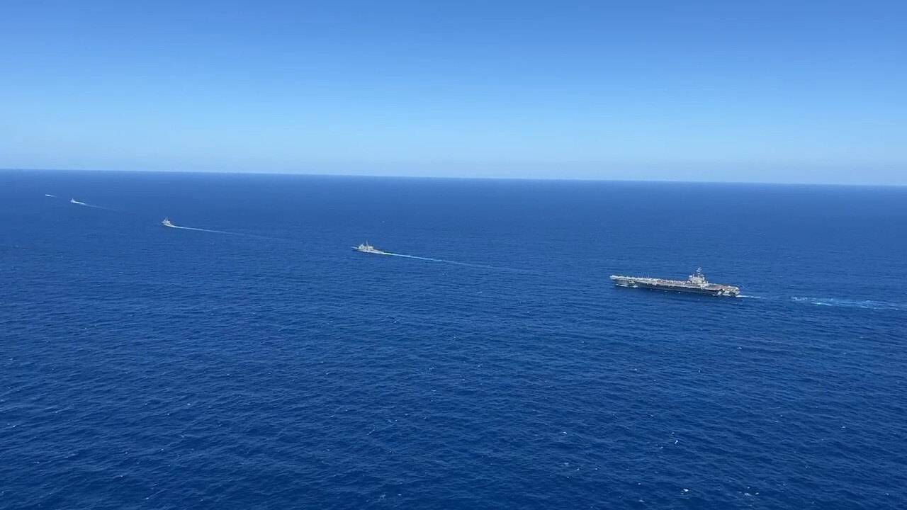 USS Ronald Reagan (CVN 76) sails in formation with HMAS Perth during Talisman Sabre 23