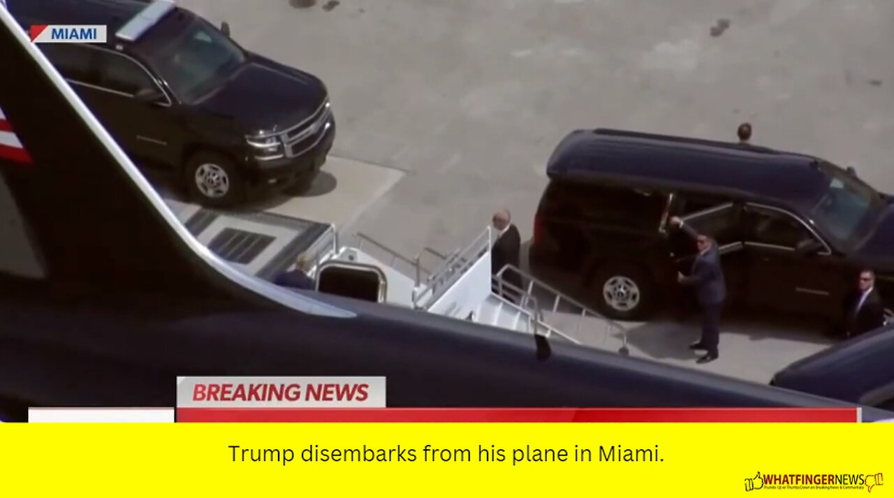 Trump disembarks from his plane in Miami.