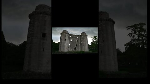 Nunney Castle with rain storm coulds above