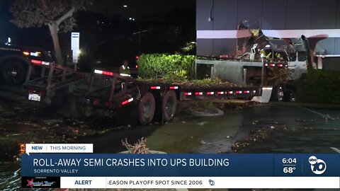 Semi-truck rolls away, crashes into building