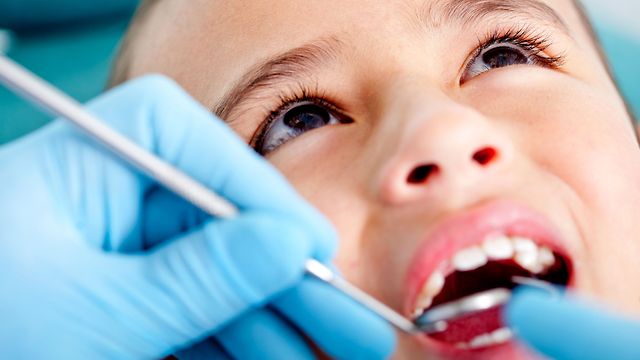 Father sneaks in on son's dentist cleaning.