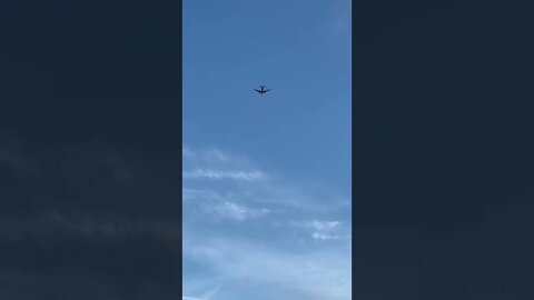 An airplane above the beach
