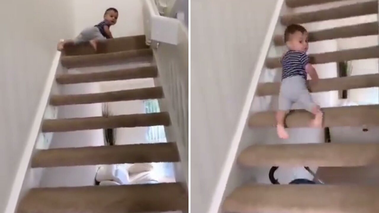 adorable baby crawling back from stairs