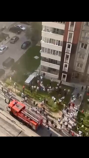 Crazy footage from Kazakhstan where children are jumping out of a high rise building on fire