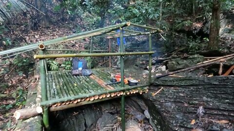 Building a bamboo shelter on a rock face:20