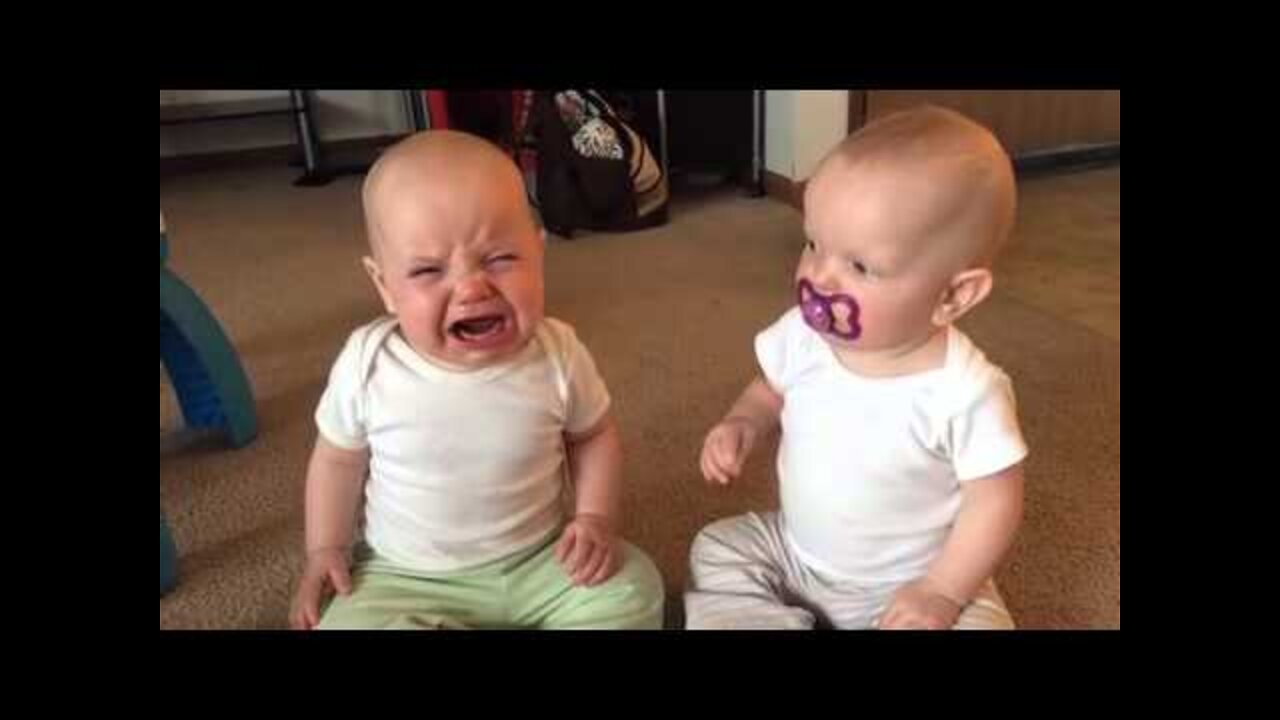 Twin baby girls fight over pacifier