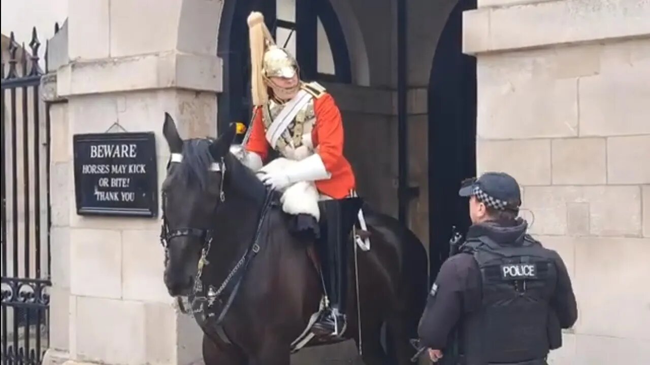 King's guard passes a mesage to other kings guard. police can you tell my buddy to slop his sword