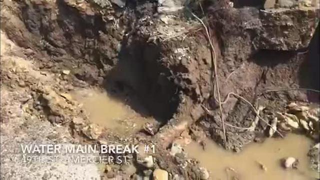 Water main break floods street near Plaza