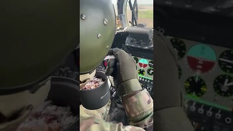 Russian Mi-24 attack helicopter gunner having breakfast during combat flight in Ukraine