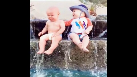 Funny babies playing with water