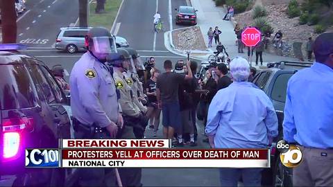 Protesters yell at officers over death of man