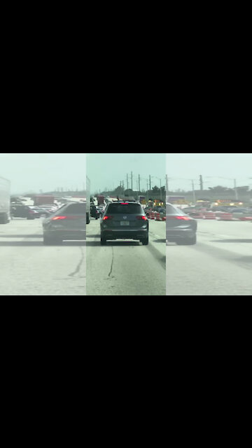 Cellphone video shows driver waving gun through sunroof on I-95