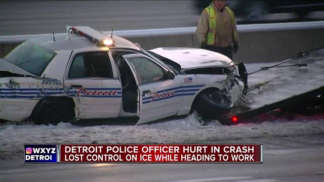 DPD officer hurt after hitting black ice, crashing into freeway wall on I-75