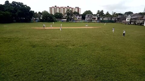 Watching a cricket match from a distance.