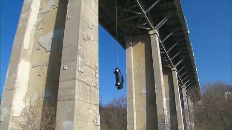 Car found dangling off overpass