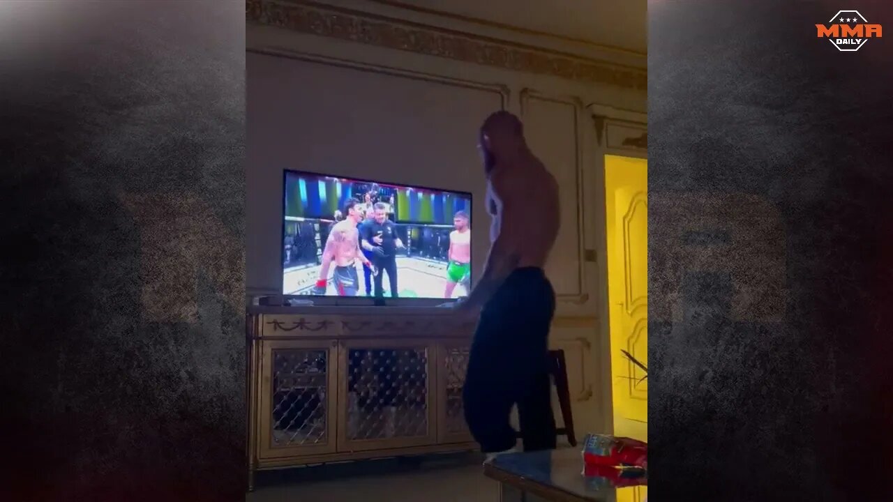 Conor McGregor staring down Max Holloway on the TV