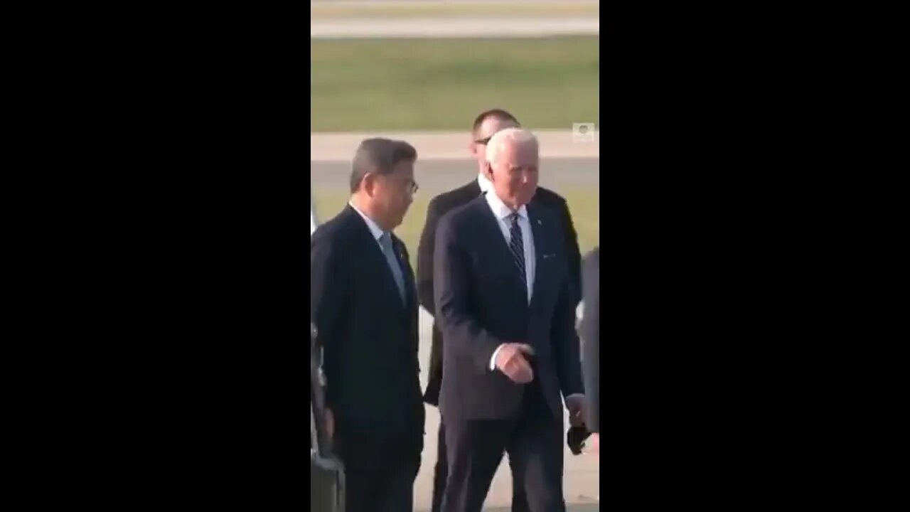 Biden wearing a mask as he exits plane by himself, then as he approaches a person he takes it off