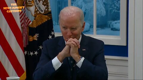 Biden stares blankly ahead while reporters ask him questions.