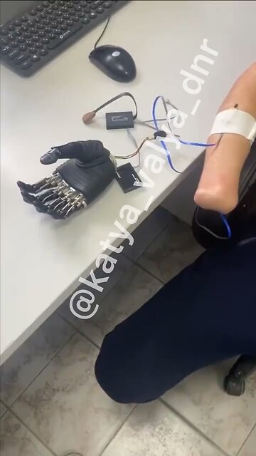 A Russian soldier getting used to his robotic prosthetic hand in Moscow