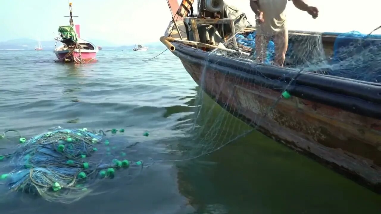 Fishermen prepare a net for fishing in the early morning. The poorest segments of the population in