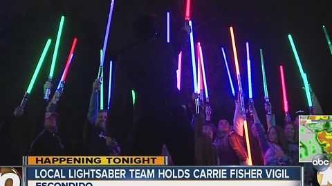 Local lightsaber team holds a Carrie Fisher vigil