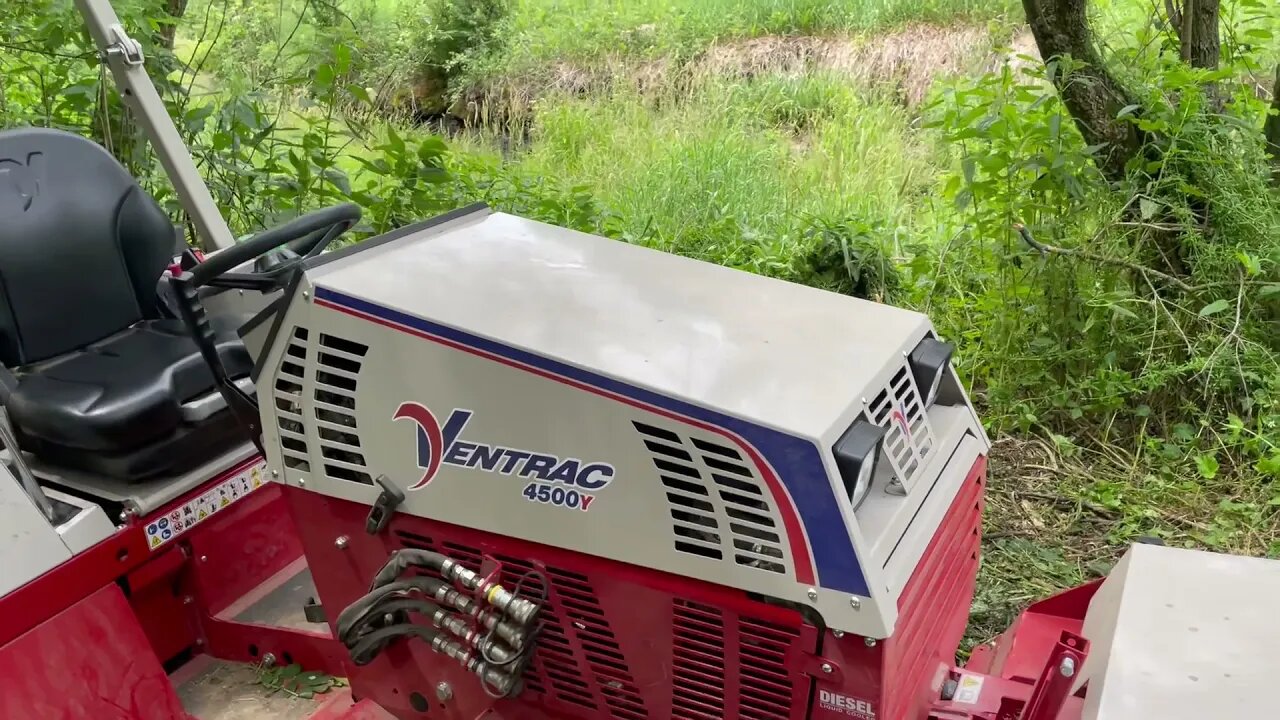 Diesel Ventrac 4500Y cutting a short trail in tall weeds and grass with tough cut deck.