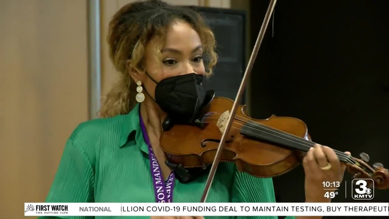 Nebraska-born violin star Ezinma plays for students at Nelson Mandela Elementary