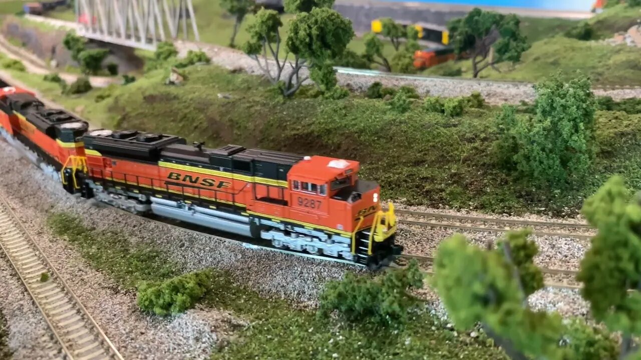 N scale empty wood chip train pulling through