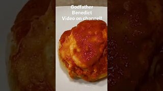 Godfather Benedict. Egg cooked in tomato sauce over English muffin with mozzarella