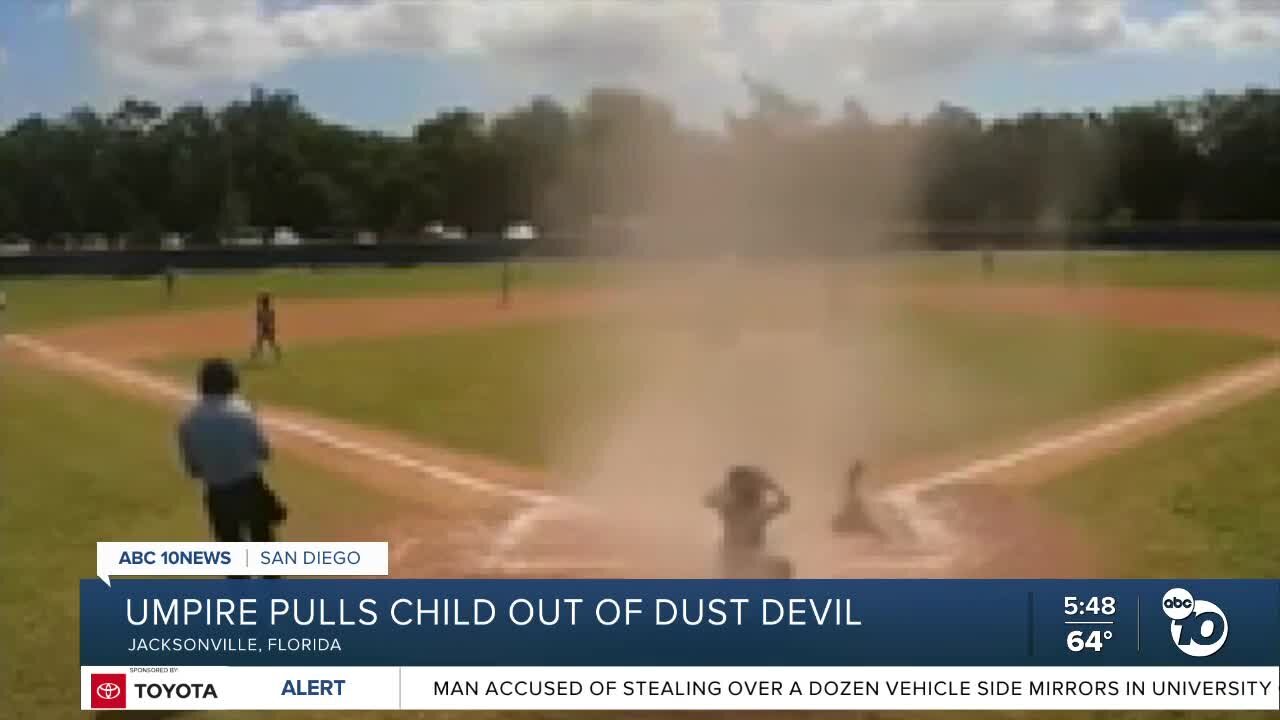 Umpire saves child from dust devil during baseball game