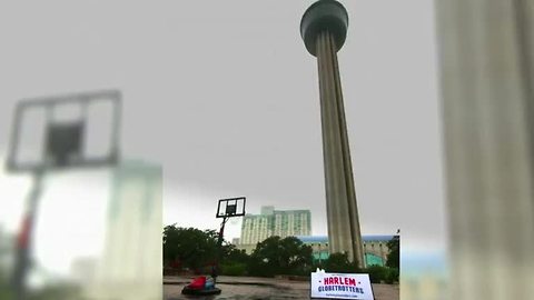 Harlem Globetrotters' star shoots basket from top of tower