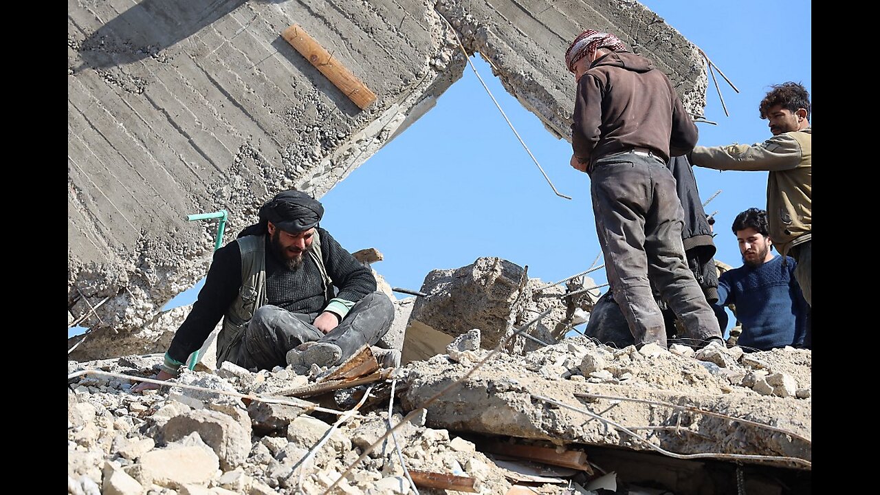 Syrian rescuers respond as buildings wrecked by fighting in town in Aleppo Governorate