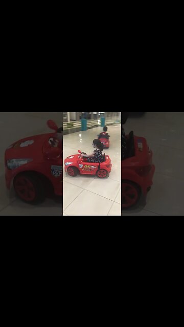 Cutie baby girl is driving her baby car